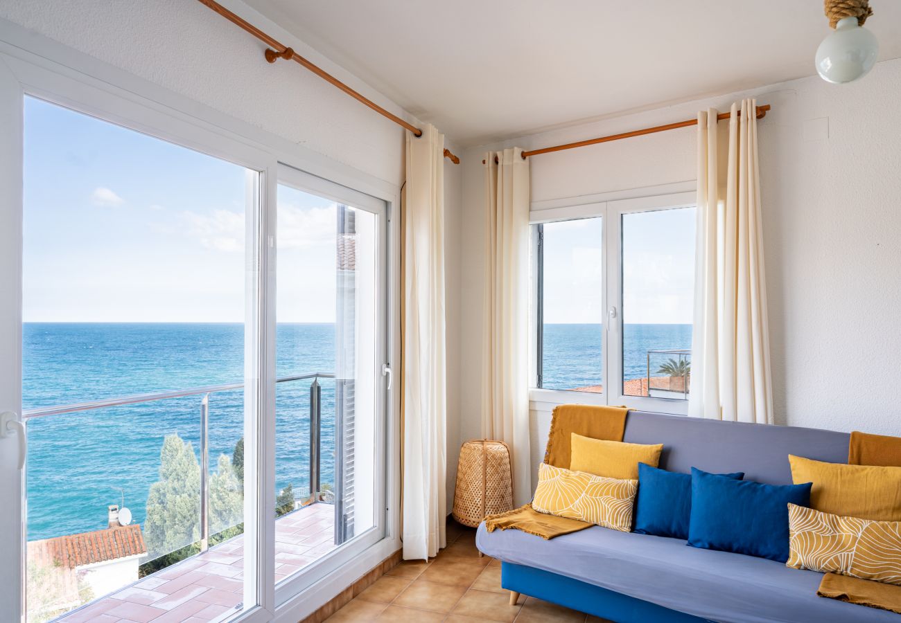 Salón con vistas al mar y acceso al balcón en un apartamento vacacional en Llançà, Costa Brava